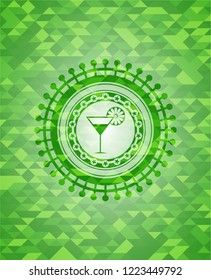 cocktail glass icon inside green emblem with mosaic ecological style background