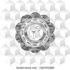 cocktail glass icon inside grey emblem with geometric cube white background