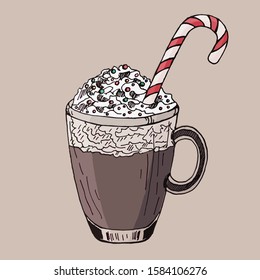 Cocoa with whipped cream and a candy cane. Christmas drink.