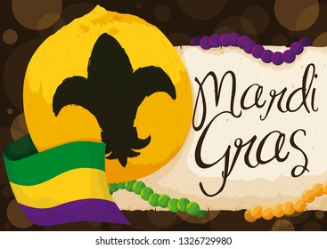 Coconut painted with golden paint and decorated with fleur-de-lys symbol, tricolor flag, necklaces and scroll with greeting message to celebrate Mardi Gras.