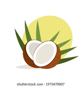 A coconut split in to halves along with its leafs