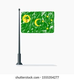Cocos Islands flag with scratches, vector flag of Cocos Islands on flagpole with shadow
