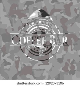 Coffee Bar written on a grey camouflage texture
