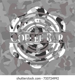 Coffee Bar written on a grey camouflage texture