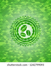 coffee bean icon inside green mosaic emblem