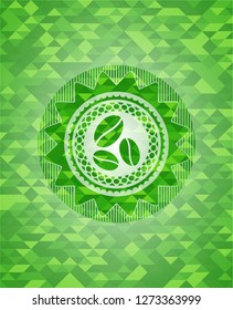 coffee bean icon inside green emblem with triangle mosaic background