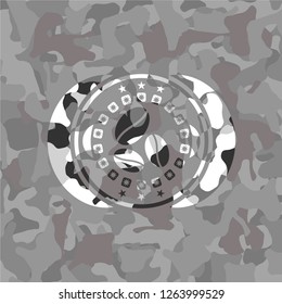 coffee bean icon inside grey camouflage emblem