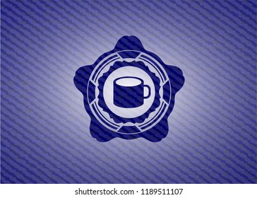 coffee cup icon inside badge with denim texture