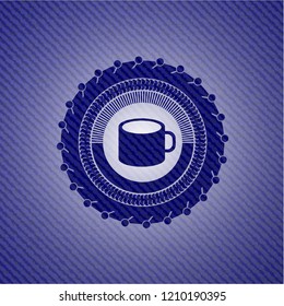 coffee cup icon inside badge with denim texture
