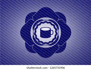 coffee cup icon inside badge with denim texture