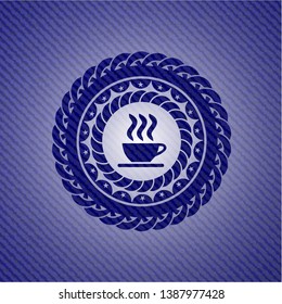 coffee cup icon inside badge with denim texture