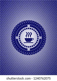 coffee cup icon inside emblem with denim texture