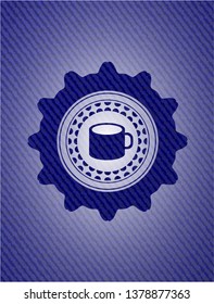 coffee cup icon inside emblem with denim texture