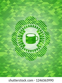 coffee cup icon inside green emblem with mosaic ecological style background