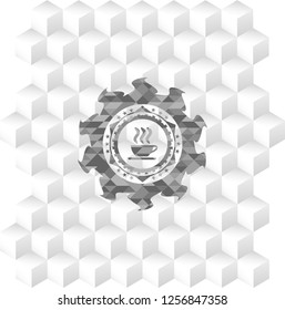 coffee cup icon inside grey emblem with geometric cube white background