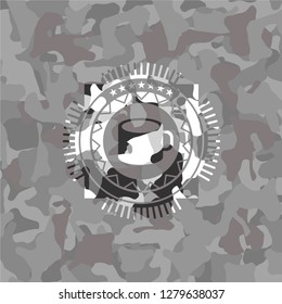 coffee cup icon inside grey camo emblem