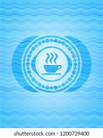 coffee cup icon inside light blue water style badge.