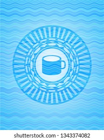 coffee cup icon inside light blue water wave style emblem.