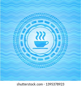 coffee cup icon inside water wave representation emblem.