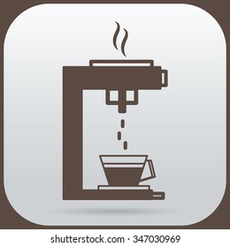 The coffee maker is dripping down the cup of coffee
