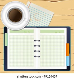 a coffee and a notebook on the desk