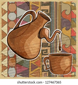 Coffee pot and cup of coffee on the ethnic patterns