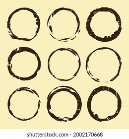Coffee stain set. Brown ring blots isolated on beige background. Vector illustration.