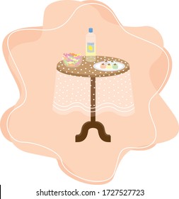 a coffee table with a white table cloth on which there are a bowl of candies,  a bottle of eau de cologne and a plate of turkish delight to serve the guests who visit for celebrating ramadan feast