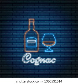 Cognac bottle and glass with lettering in neon style on brick background. Alcohol cocktail bar symbol, logo, signboard.