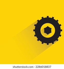cogwheel with shadow on yellow background