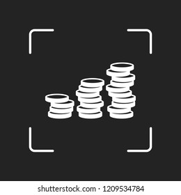 Coins stack, finance grow. White object in camera autofocus on dark background