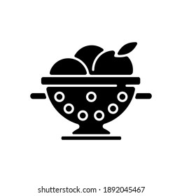 Colander black glyph icon. Strainer to rinse fruits. Wash fruits in pot with holes. Kitchen tool for cooking. Utensil for preparing food. Silhouette symbol on white space. Vector isolated illustration