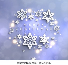 Cold blue sparkling Christmas background with frame made of cutout paper snowflakes 
