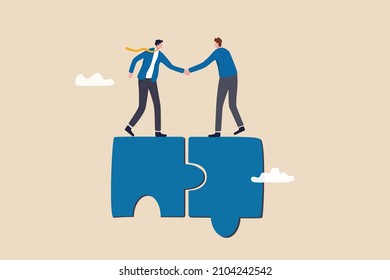 Collaborate, cooperate or partnership and agreement to help business success, together or teamwork support each other concept, success businessmen finish deal and handshake on jigsaw puzzle.