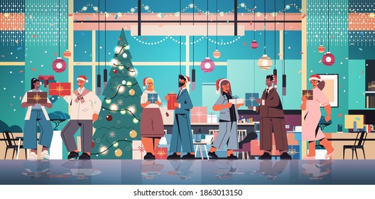 colleagues in santa hats holding gifts mix race coworkers celebrating new year and christmas holidays office interior horizontal full length vector illustration