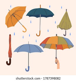 Collection of autumn umbrellas. Yellow, blue, blue, green. Open and closed umbrellas. Raindrops. vector hand drawn illustration.