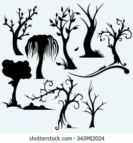 Collection of bare trees. Isolated on blue background. Vector silhouettes