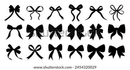 A collection of black bows with varying sizes and shapes. The bows are all black and are arranged in a row