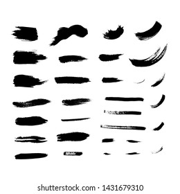 A collection of black brush strokes and spots in a white background. 