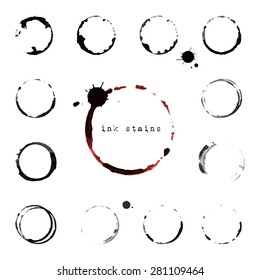 Collection of black ink round stains and blots on white background