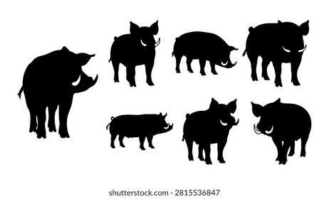 Collection of black silhouettes depicting different wild animals including pigs, dogs, and boars in a group setting.