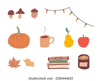 Collection of cosy autumn items, hygge september with candle, books, tea mug, pumkin and lights