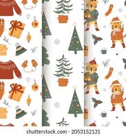 Collection of cute Christmas seamless patterns. Image of winter clothes, New Year's tigers, trees, gifts. Vector illustration.