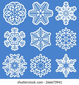 collection of different white snowflakes on blue background