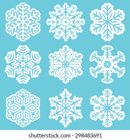 collection of different white snowflakes on blue background