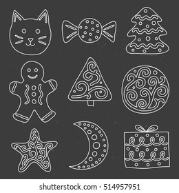 Collection of doodle cute outline cookies with icing isolated on the blackboard.