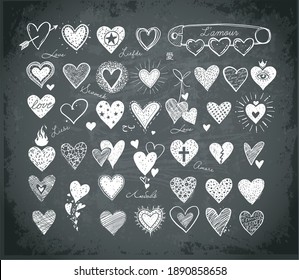 Collection of doodle sketch hearts on blackboard background. "Love" inscription in different languages