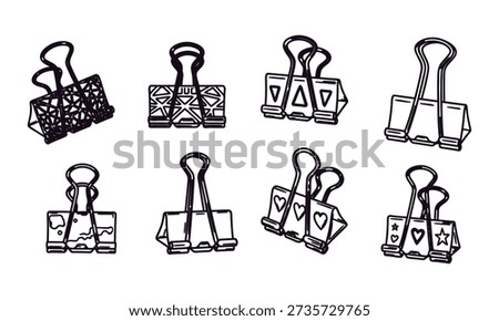Collection of eight different binder clips on white background