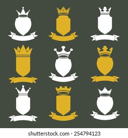 Collection of empire design elements. Heraldic royal coronet illustration. Set of luxury vector shields with king crown and undulate festive ribbon.  