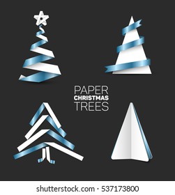 Collection of four christmas trees made from white and blue metalic paper or  paper stripes on dark background